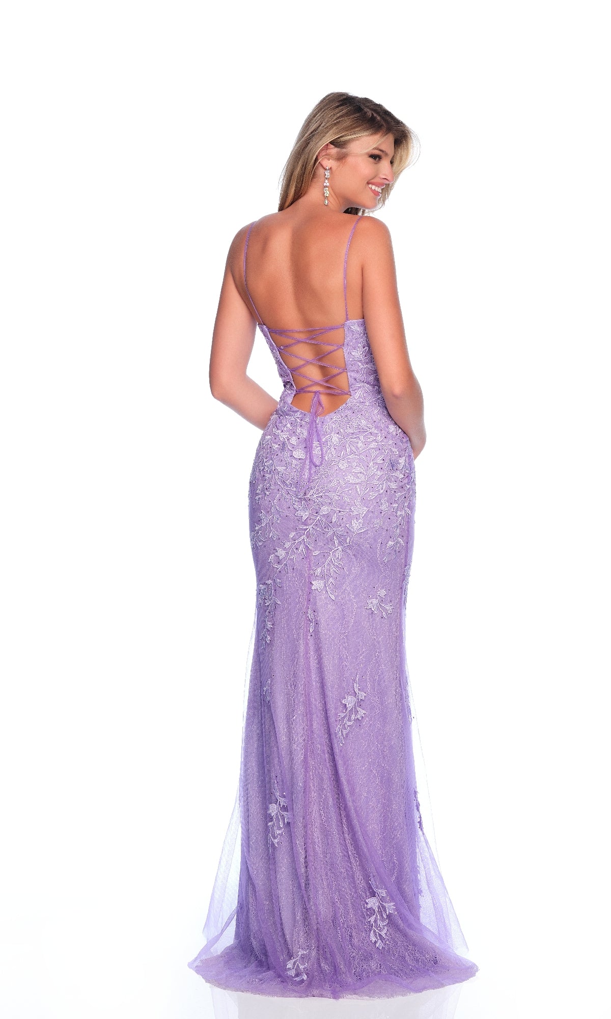 A woman faces away wearing the Dave & Johnny 12314 Lace Prom Dress in lavender, featuring floral lace appliques, a lace-up open back, and delicate thin shoulder straps.
